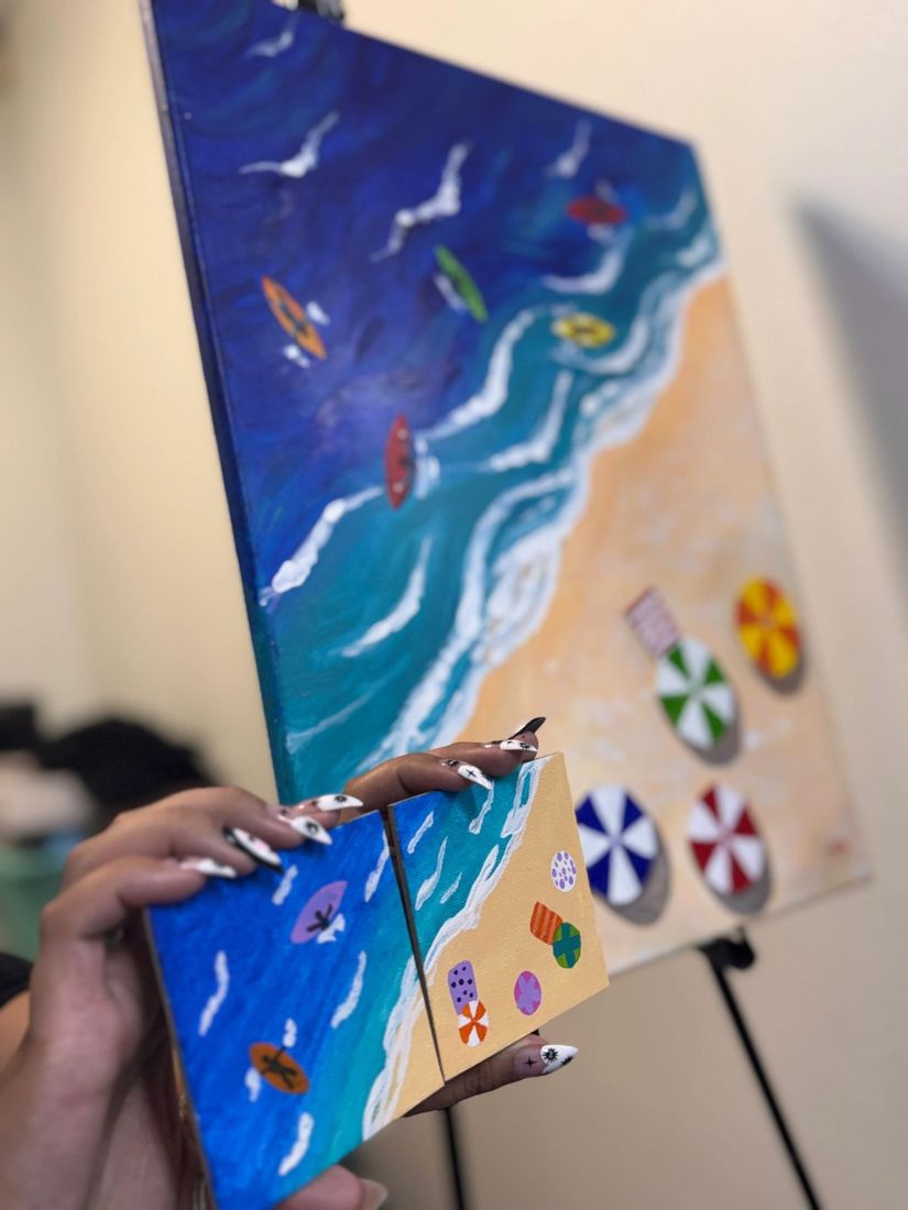 A painted beach canvas on an easel